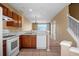 Cozy kitchen with wood cabinets and white appliances at 4517 Kennewick Pl, Riverview, FL 33578