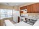 Clean kitchen with white appliances and wood cabinets at 4517 Kennewick Pl, Riverview, FL 33578