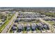 Aerial view of a new neighborhood with many houses and a pond at 9917 Spanish Lime Ct, Riverview, FL 33578