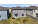 Backyard view of the house with fence and grassy area at 9917 Spanish Lime Ct, Riverview, FL 33578