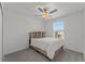 Bright bedroom with a double bed, carpet flooring, and window coverings at 9917 Spanish Lime Ct, Riverview, FL 33578