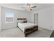 Charming bedroom with a rustic wooden bed frame and ample natural light at 9917 Spanish Lime Ct, Riverview, FL 33578