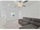 Relaxing common area with a sectional sofa and large window at 9917 Spanish Lime Ct, Riverview, FL 33578