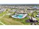 Aerial view of community pool, clubhouse, and playground at 9917 Spanish Lime Ct, Riverview, FL 33578