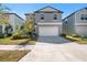 Two-story house with gray siding and a two-car garage at 9917 Spanish Lime Ct, Riverview, FL 33578