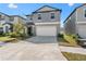 Beautiful gray two-story home with a large driveway leading to an attached two-car garage at 9917 Spanish Lime Ct, Riverview, FL 33578