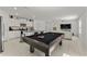 Pool table and kitchen with granite countertop island at 9917 Spanish Lime Ct, Riverview, FL 33578