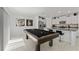 Pool table near kitchen with granite countertop island at 9917 Spanish Lime Ct, Riverview, FL 33578