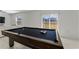 Pool table in a well-lit game room with backyard access at 9917 Spanish Lime Ct, Riverview, FL 33578