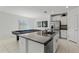 Kitchen island with granite countertops and stainless steel appliances at 9917 Spanish Lime Ct, Riverview, FL 33578