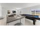 Kitchen island with granite countertop and pool table view at 9917 Spanish Lime Ct, Riverview, FL 33578