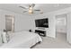 Spacious main bedroom with large TV, ensuite bathroom, and walk-in closet at 9917 Spanish Lime Ct, Riverview, FL 33578