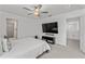 Main bedroom with large TV, en-suite bathroom, and walk-in closet at 9917 Spanish Lime Ct, Riverview, FL 33578