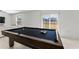 Pool table in open living area next to sliding glass doors at 9917 Spanish Lime Ct, Riverview, FL 33578