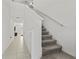 Modern staircase with gray carpeting and white railings at 9917 Spanish Lime Ct, Riverview, FL 33578