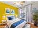 Stylish bedroom features bright yellow walls, gray accents, nautical-themed decor, and a comfortable bed at 1020 85Th N Ave # 223, St Petersburg, FL 33702