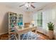 Serene home office with a white desk, bookshelf, bright blue chair, and natural light streaming through the window at 1020 85Th N Ave # 223, St Petersburg, FL 33702