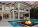 Luxurious outdoor living space featuring pool, fireplace, covered patio, and elegant seating and dining areas at 105 Cordova Ne Blvd, St Petersburg, FL 33704
