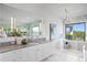 Elegant bathroom with double vanities, a soaking tub, glass shower, and a large window offering water views at 105 Cordova Ne Blvd, St Petersburg, FL 33704