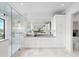 Bright bathroom featuring a glass shower, double vanities, marble countertops, and modern fixtures at 105 Cordova Ne Blvd, St Petersburg, FL 33704