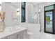 Bathroom featuring a walk-in shower with glass door, grey vanity, and modern fixtures at 105 Cordova Ne Blvd, St Petersburg, FL 33704