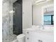 Modern bathroom with glass shower, vanity, and marble countertops at 105 Cordova Ne Blvd, St Petersburg, FL 33704