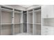 Walk-in closet with white cabinets, drawers, and hanging rods at 105 Cordova Ne Blvd, St Petersburg, FL 33704