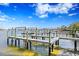 A wooden boat dock on the water, set against a clear sky, is ready for maritime adventures and relaxation at 105 Cordova Ne Blvd, St Petersburg, FL 33704