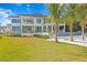 The modern home features a spacious lawn, a pool with spa, and an outdoor entertaining area at 105 Cordova Ne Blvd, St Petersburg, FL 33704