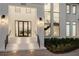 Front entrance of a modern home with an illuminated staircase, and glass windows looking onto the interior at 105 Cordova Ne Blvd, St Petersburg, FL 33704