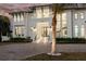 Beautiful two-story home featuring grand entrance with stairs leading to a modern, black-framed glass door at 105 Cordova Ne Blvd, St Petersburg, FL 33704