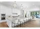 Bright kitchen with white cabinets, marble counters, and stainless steel appliances overlooking backyard at 105 Cordova Ne Blvd, St Petersburg, FL 33704
