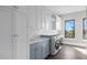 Well-organized laundry room with white cabinets, modern washer/dryer, and plenty of storage space at 105 Cordova Ne Blvd, St Petersburg, FL 33704