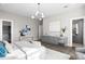 Bright main bedroom featuring a beverage bar, hardwood floors, modern lighting and access to ensuite bathroom at 105 Cordova Ne Blvd, St Petersburg, FL 33704