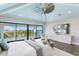 Bright main bedroom with a vaulted blue ceiling, large windows overlooking the water, and stylish decor at 105 Cordova Ne Blvd, St Petersburg, FL 33704