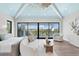 Beautiful primary bedroom featuring a vaulted ceiling, large windows with water views, and modern furnishings at 105 Cordova Ne Blvd, St Petersburg, FL 33704