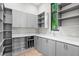 Organized mud room with gray cabinetry, open shelving, and ample storage at 105 Cordova Ne Blvd, St Petersburg, FL 33704