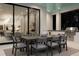 Covered outdoor dining area with an elegant table, chairs, grill, and a glimpse of the modern kitchen at 105 Cordova Ne Blvd, St Petersburg, FL 33704