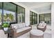 Covered patio features comfortable seating and views of the tropical landscaping at 105 Cordova Ne Blvd, St Petersburg, FL 33704