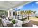Covered outdoor seating area with comfortable furnishings and views of the pool and waterfront at 105 Cordova Ne Blvd, St Petersburg, FL 33704