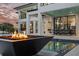 Backyard pool with a fire pit, outdoor dining, covered patio, and open views to interior living spaces at 105 Cordova Ne Blvd, St Petersburg, FL 33704