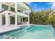 A luxurious pool and spa are surrounded by lush landscaping and an outdoor kitchen, perfect for entertaining at 105 Cordova Ne Blvd, St Petersburg, FL 33704