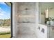 Bright shower with herringbone tile, niche, glass enclosure, and view at 105 Cordova Ne Blvd, St Petersburg, FL 33704