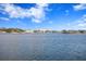 A beautiful waterfront view of upscale homes with a serene body of water under a clear, blue sky at 105 Cordova Ne Blvd, St Petersburg, FL 33704