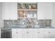 Modern wet bar with marble backsplash, open shelving, and a mini fridge at 105 Cordova Ne Blvd, St Petersburg, FL 33704