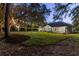 Peaceful backyard with string lights and lush landscaping at 4586 Hickory Oak Dr, Brooksville, FL 34601