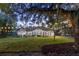 Serene backyard with string lights under the trees at 4586 Hickory Oak Dr, Brooksville, FL 34601