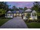 Modern home with gray siding, black accents, and a brick driveway at 4586 Hickory Oak Dr, Brooksville, FL 34601