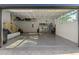 Garage with epoxy flooring, overhead storage, and built-in cabinets at 4586 Hickory Oak Dr, Brooksville, FL 34601