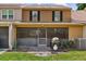 Backyard view of exterior and screened-in patio with a grill and grassy yard at 5325 Bradbury Ct, Tampa, FL 33624